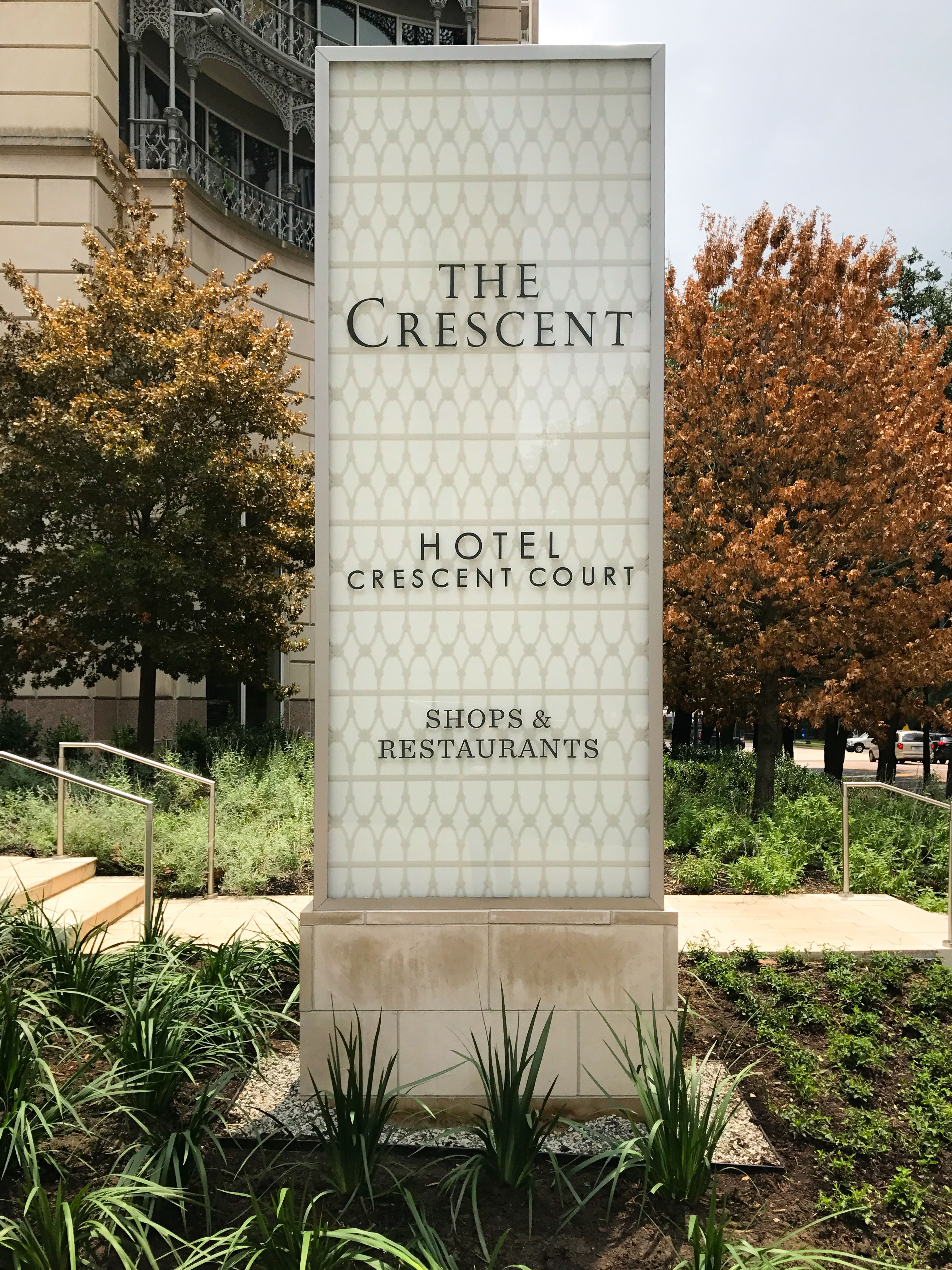 A monument sign featuring the Hotel Crescent Court logo with individual aluminum letters.