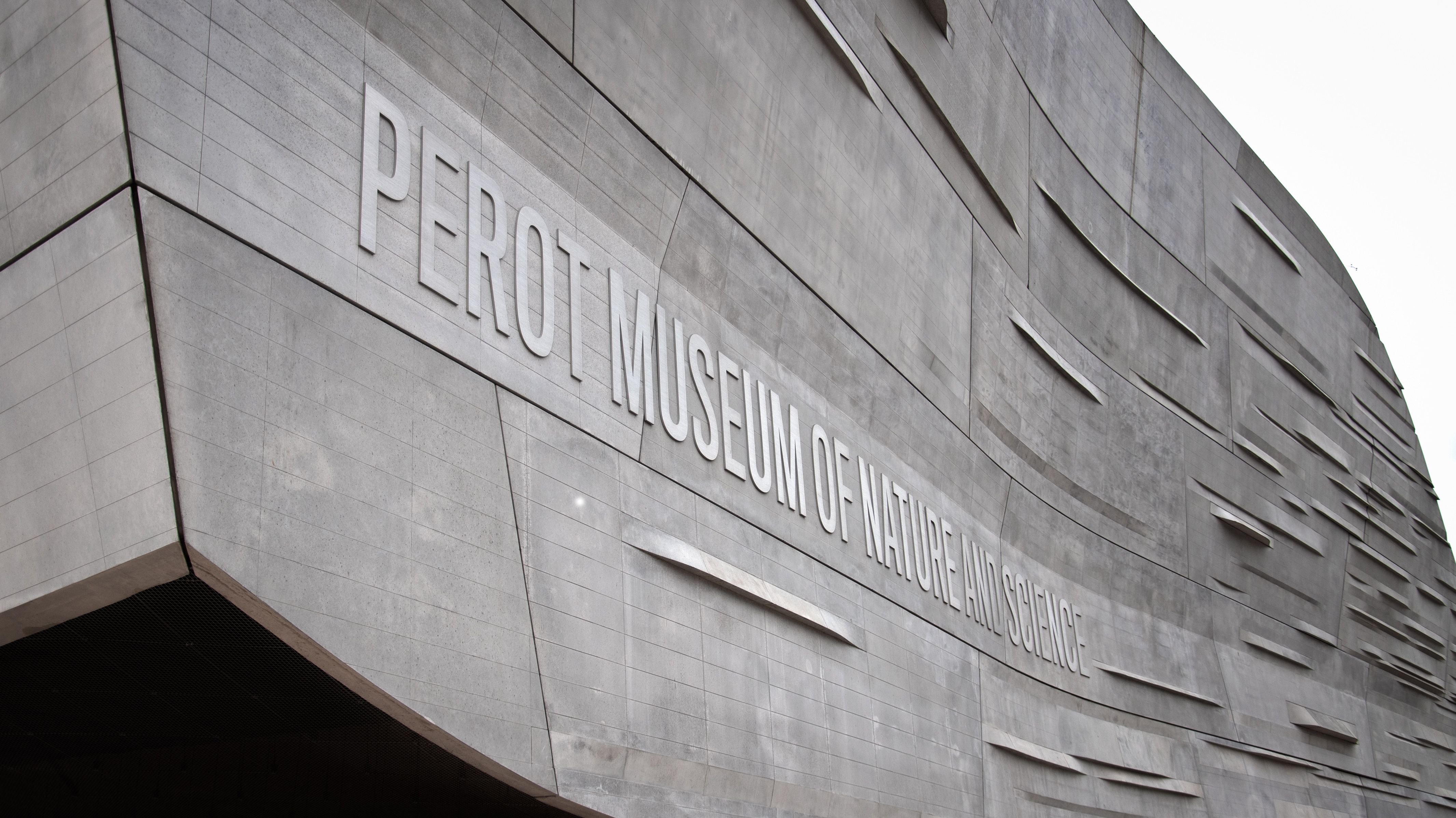 "Perot Museum of Nature and Science" aluminum cut letters mounted to the concrete exterior of the museum in Dallas, Texas.