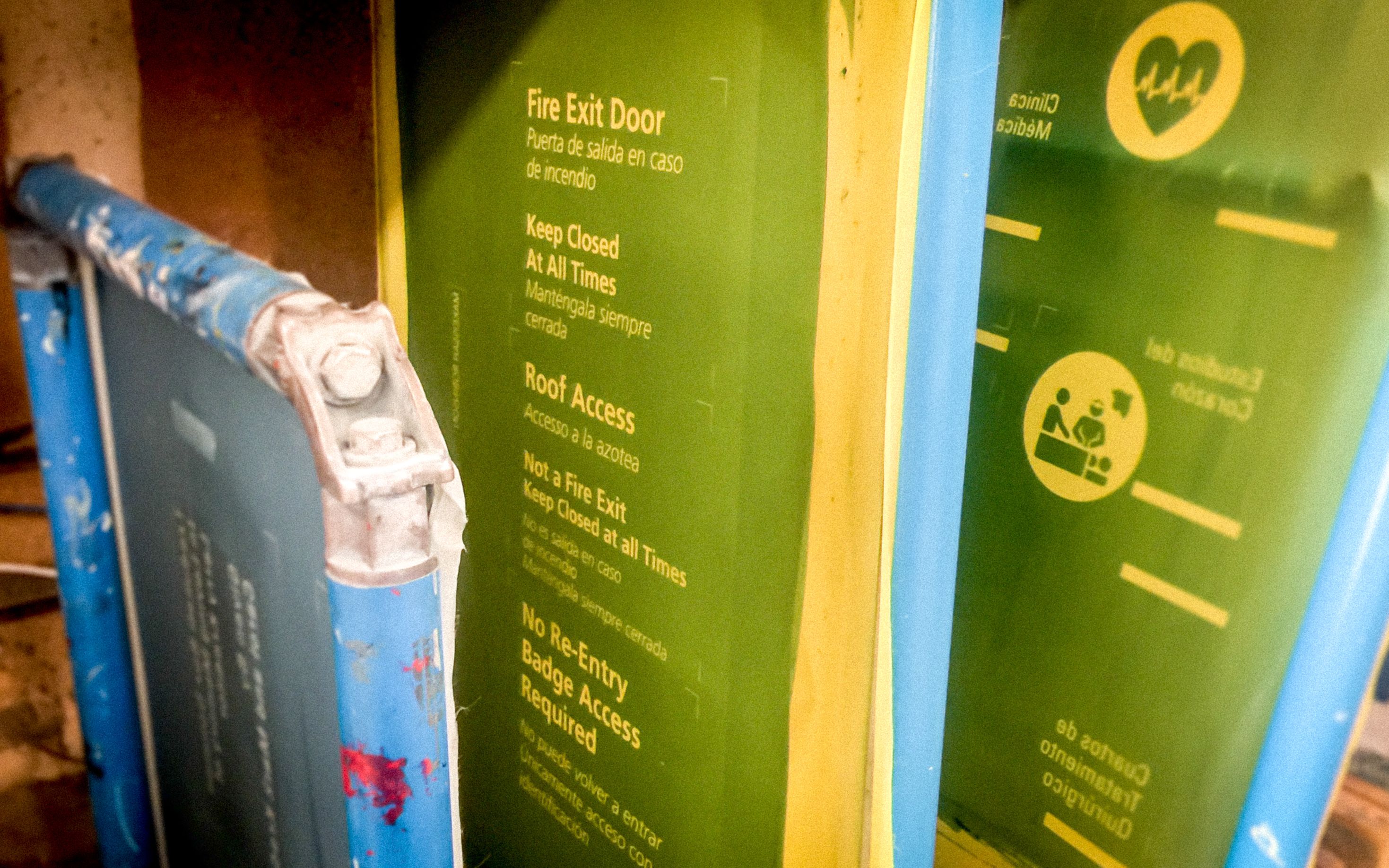 Several screenprint screens are lined up in a row, with various medical and saftey symbols and text.